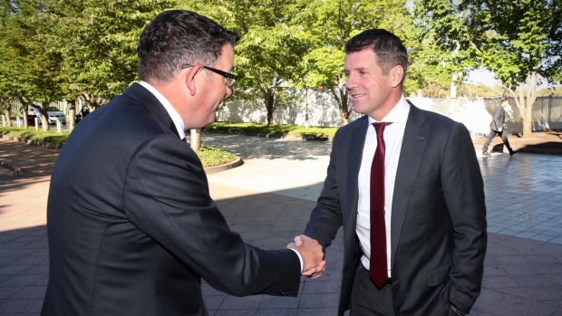 Victorian Premier Daniel Andrews greets NSW Premier Mike Baird ahead of COAG in Canberra on Friday.