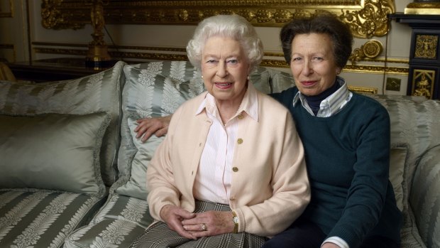 The Queen's only daughter Princess Anne sitting with her arm wrapped protectively around her mother.