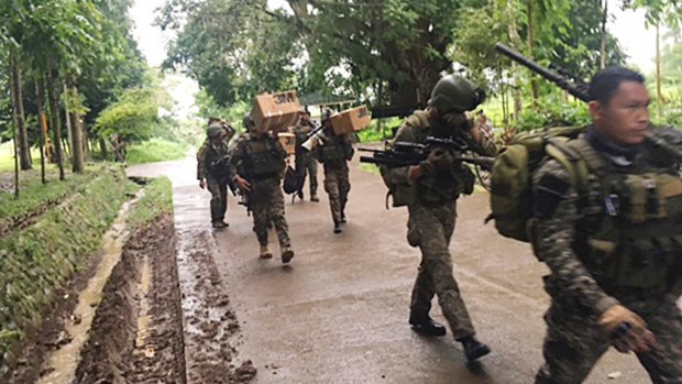 Philippine troops arrive at their barracks to reinforce fellow troops following the siege by Muslim militants in the outskirts of Marawi city in southern Philippines.