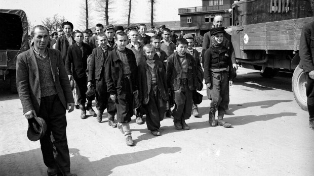 This April 1945 file photo shows prisoners liberated by the US Army marching from the Buchenwald concentration camp near Weimar, Germany. The tall youth in the line at left, fourth from the front, is Elie Wiesel. 