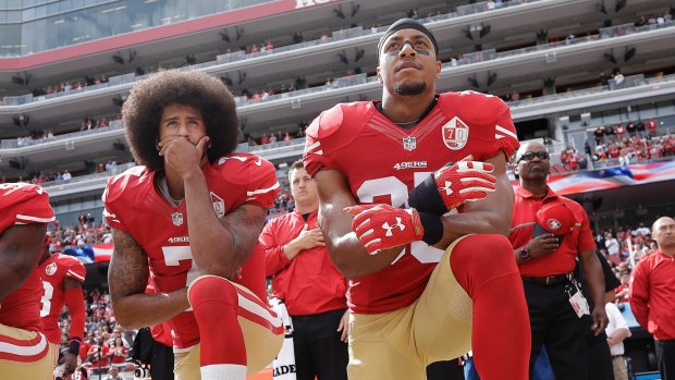 Colin Kaepernick (left) and Eric Reid kneel during the national anthem in October 2016.