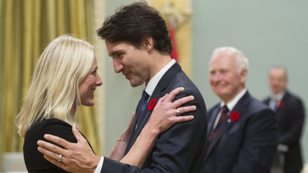 Canadian Prime Minister Justin Trudeau hugs Environment and Climate Change Minister Catherine McKenna after the new cabinet took the oath of office at Rideau Hall, the governor-general's residence, in Ottawa on November 4.