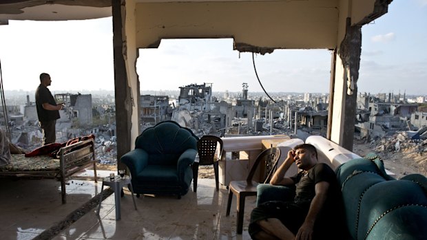 Adel (right) and Mohammed spend the afternoon in the only room of their home not totally destroyed after an Israeli missile in 2014.