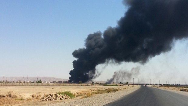 Smoke rises from the Baiji refinery in June.