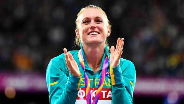 Sally Pearson celebrates her incredible victory on the podium.