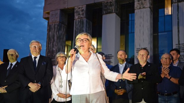 Head of Poland's Supreme Court Malgorzata Gersdorf, surrounded by judges, speaks to protesters gathered in front of the court building in Warsaw, Poland, July 24, 2017.
