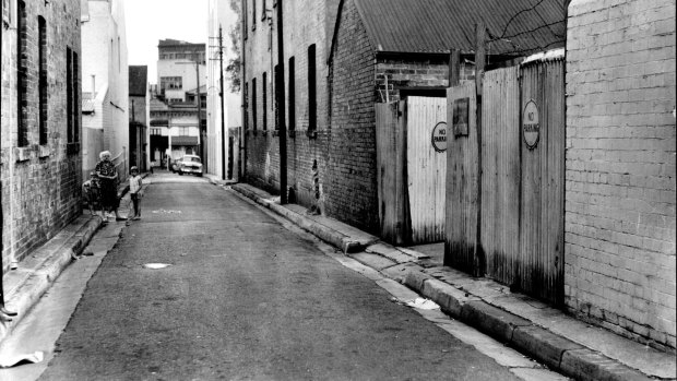 The body of Frank McLean, William Macdonald's third victim, was found in the gutter in front of the gates in the right foreground of this picture of Little Bourke Street, Darlinghurst, on a Saturday night in 1962.