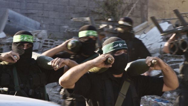 Hamas militants carry mortar rounds in August 2014. 