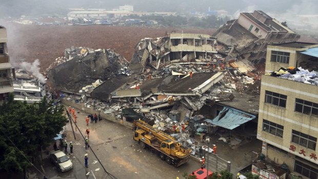 Rescuers search for survivors among the collapsed buildings after a landslide in Shenzhen, in China's southern  Guangdong province on Sunday.