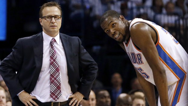 Scott Brooks (left) and forward Kevin Durant apuse for a break.