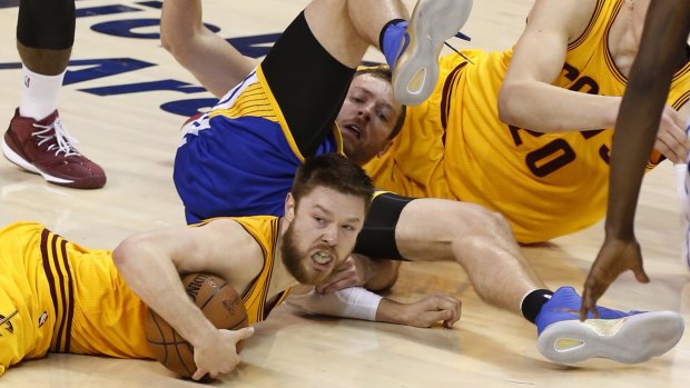In and under: Cleveland Cavaliers guard Matthew Dellavedova comes up with the ball.
