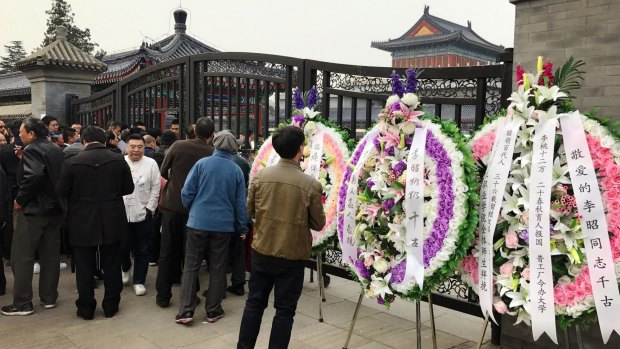 People queue at the gates of Babaoshan Revolutionary Cemetery to attend Li Zhao's funeral on March 17.