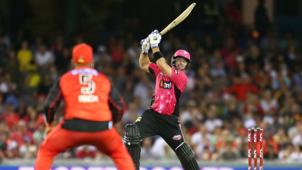 In control: Michael Lumb belts a six as Renegades' skipper Aaron Finch watches on.