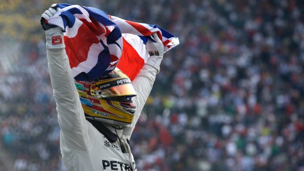 British driver Lewis Hamilton celebrates wining his fourth Formula One championship.