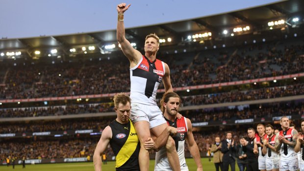 All-time great: Nick Riewoldt is carried from the ground by his cousin Jack, and St Kilda teammate Josh Bruce.