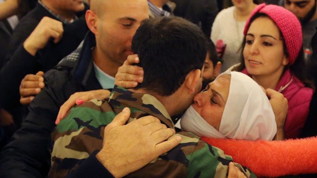 A Lebanese soldier who was kidnapped by the Nusra Front embraces his mother upon  arrival  in Beirut.