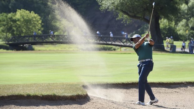 Jason Day hits out of a bunker on the 14th hole during the first round at the Canadian Open.
