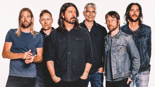 Dave Grohl (centre) will bring the Foo Fighters to Australia in January as part of their world tour.