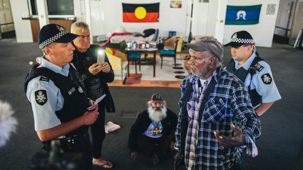 Uncle Kevin Buzzacott (right) of the tent embassy speaks to police during the occupation in November.
