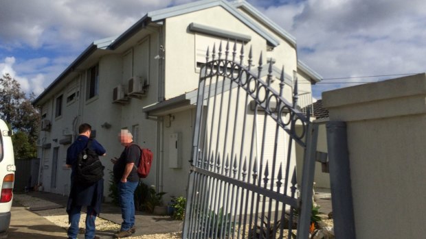 AFP officers outside Richard Vong's house in the Melbourne suburb of Thomastown, which was raided on Wednesday.