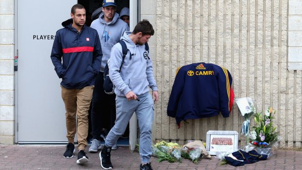 Players leave the clubrooms at Adelaide Crows headquarters.