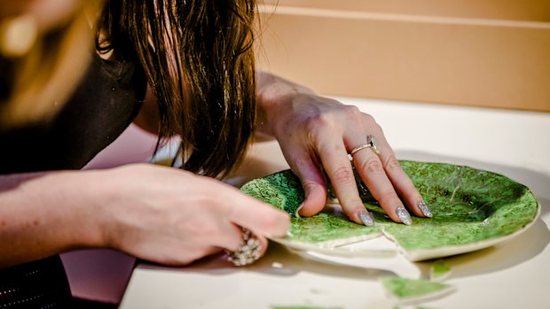 A broken plate is carefully repaired.