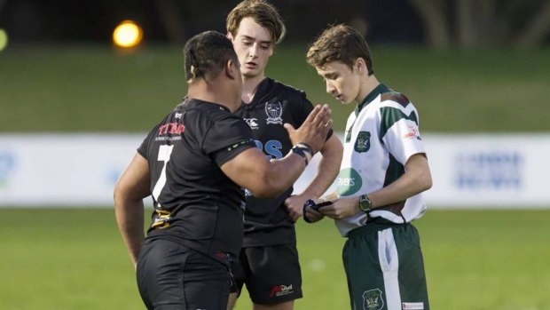 Maitland Blacks breakaway Mark Meafua, left, lashes out at referee Niklas Gaal, right.