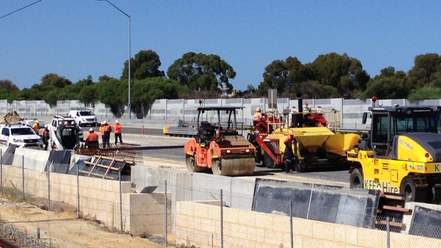 Work crews constructing the new freeway extension.