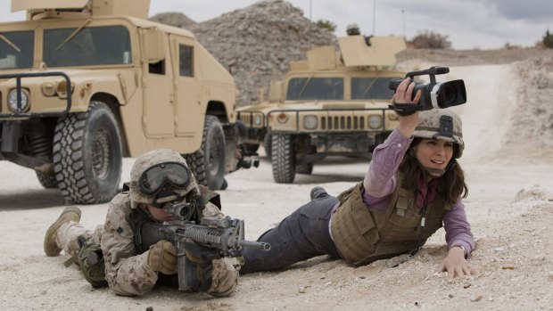 Evan Jonigkeit, left, plays Specialist Coughlin and Tina Fey plays Kim Baker in <i>Whiskey Tango Foxtrot</i>.