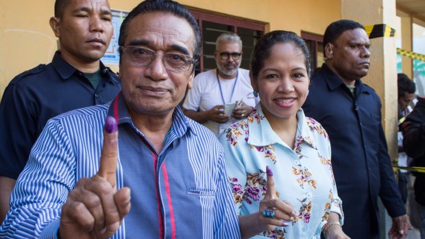 East Timorese President Francisco "Lu-Olo Guterres" and his wife show their fingers after voting in Dili.
