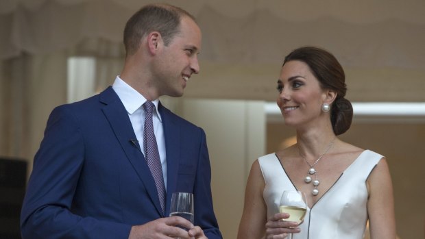 Kate Middleton wears a white dress by Polish designer Gosia Baczynska as she and husband Prince William enjoy a toast to the Queen.