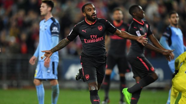 Gun debut: Alexandre Lacazette celebrates his first goal in an Arsenal jersey, against Sydney FC at ANZ Stadium on Thursday night.