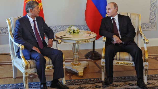 Vladimir Putin and the President of Kyrgyzstan, Almazbek Atambayev attend a meeting in Saint Petersburg.