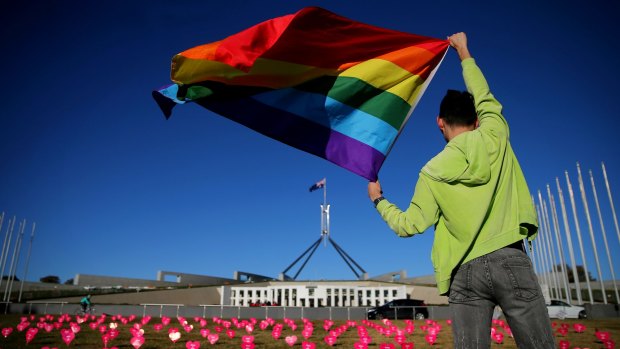 Marriage equality advocate Russell Nankervis with the rainbow flag during a 'Sea of Hearts' event in support of marriage equality at Parliament House earlier this month.