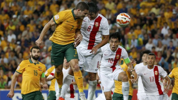 Six-yard threat: Mathew Leckie heads for goal against China during the Socceroos' quarter-final in Brisbane.