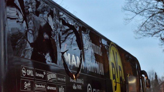 A window of Dortmund's team bus is damaged after an explosion.