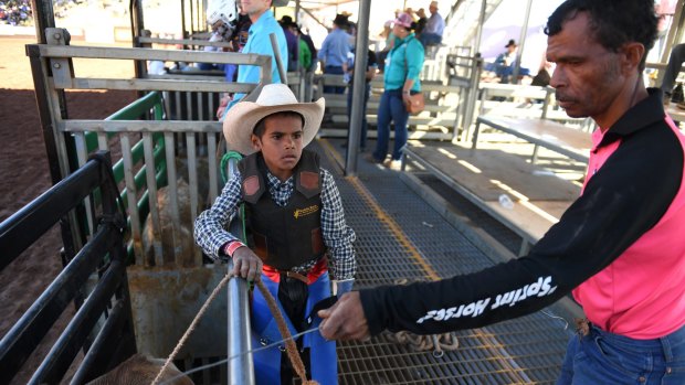 Peter Gregory jnr with his father Peter snr as he prepares to compete at the rodeo.