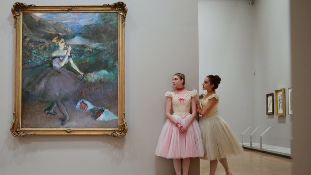 The Australian Ballet's performers in front of  'Dancer with bouquets' at the launch of Degas: A New Vision at NGV International.