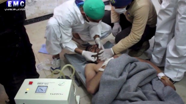 A victim of a suspected chemical attack receives treatment at a makeshift hospital.