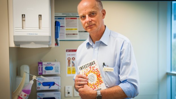 Professor Frank Bowden with a copy of his book, 'Infectious'.