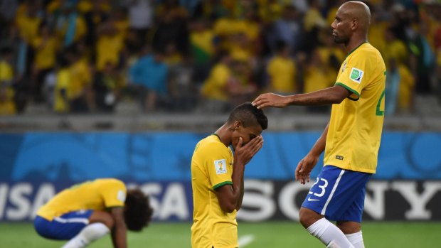 Unhappy ending: Brazil's Luis Gustavo is consoled by Maicon after the home nation's humiliating 7-1 defeat to Germany in the World Cup semi-final.
