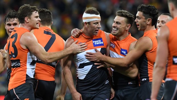 How the west was won: The Giants celebrate with veteran Steve Johnson (centre) after thrashing the Eagles.
