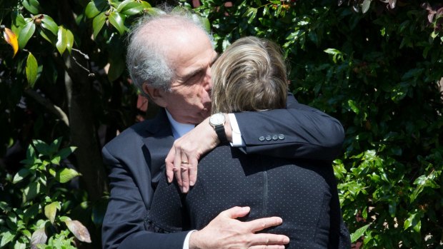 Siblings Garth Symonds and Anna Cleary console each other after the funeral of their mother, Lady (Mary) Fairfax.