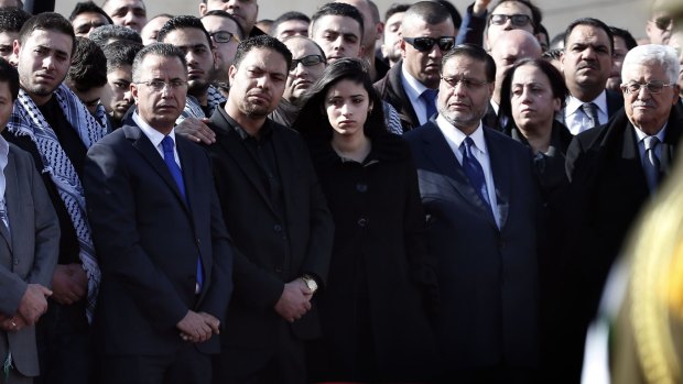 Palestinian Authority President Mahmoud Abbas (far right) stands with members of Ziad Abu Ein's family at the funeral.