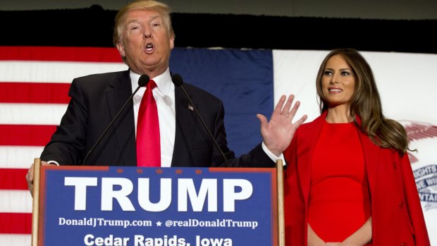 Republican presidential candidate Donald Trump, accompanied by his wife Melania Trump in Iowa. Ted Cruz has accused Mr Trump of stoking false rumours about his personal life.