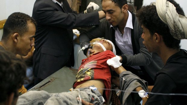 A boy injured in crossfire during fighting between fighters of the Popular Resistance Committees and Houthi fighters is rushed to hospital in Yemen's south-western city of Taiz on Monday. 