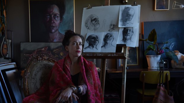 Artist Mirra Whale in her Marrickville studio, with sketches she made of Philip Nitschke.
