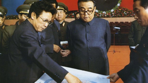 Then North Korean leader Kim Il Sung, centre, and his son Kim Jong Il, left, talk about the preparation for the convention of North Korea's Workers' Party in Pyongyang in 1980.