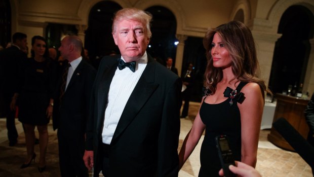 Donald Trump and his wife Melania Trump arrive for a New Year's Eve party at Mar-a-Lago.