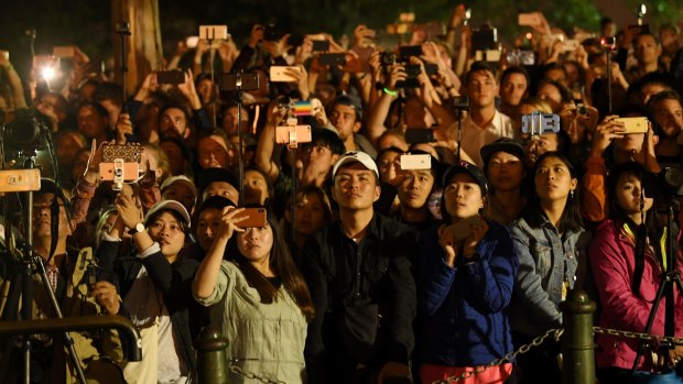 Crowds capture the moment during the Sydney Harbour fireworks on New Year's Eve.